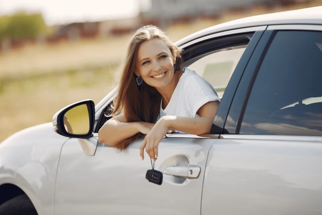 Women in car after just purchasing car insurance