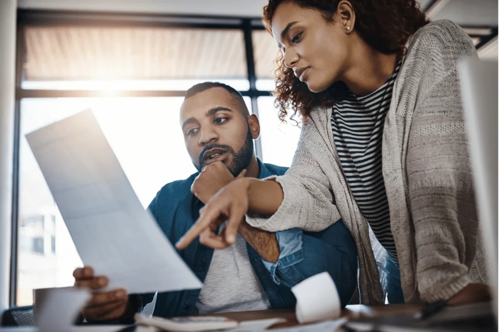 Woman showing man some paperwork