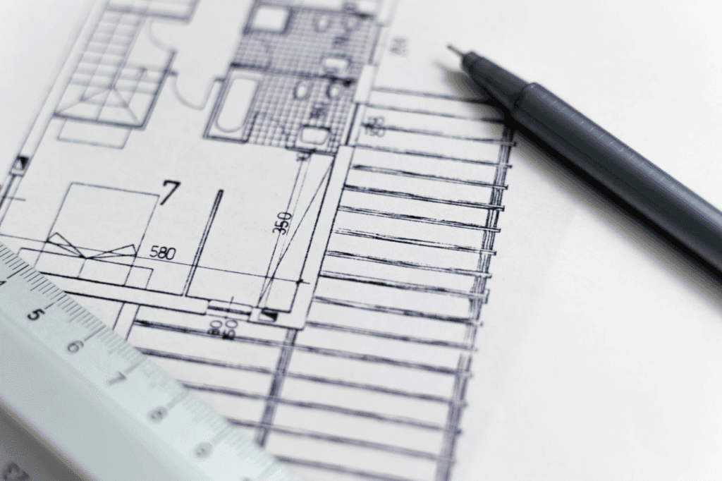 Building plans being drawn with a pen