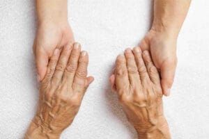 Old women holding daughters hands