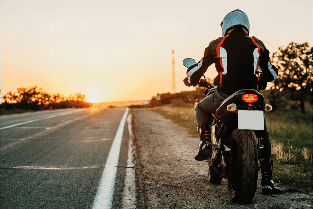 Man on Motorcycle on side of street