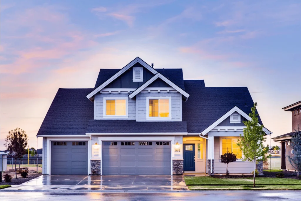 Two story blue home with grassy front yard